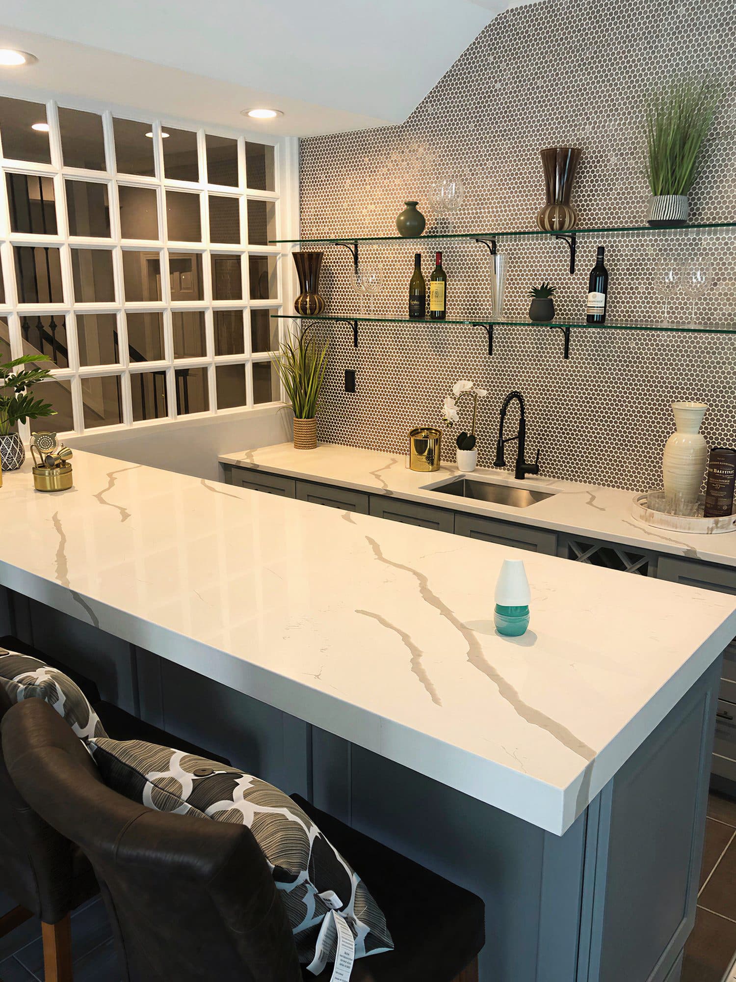 Custom built-in wet bar in Potomac, MD, glass shelving and penny tile backsplash