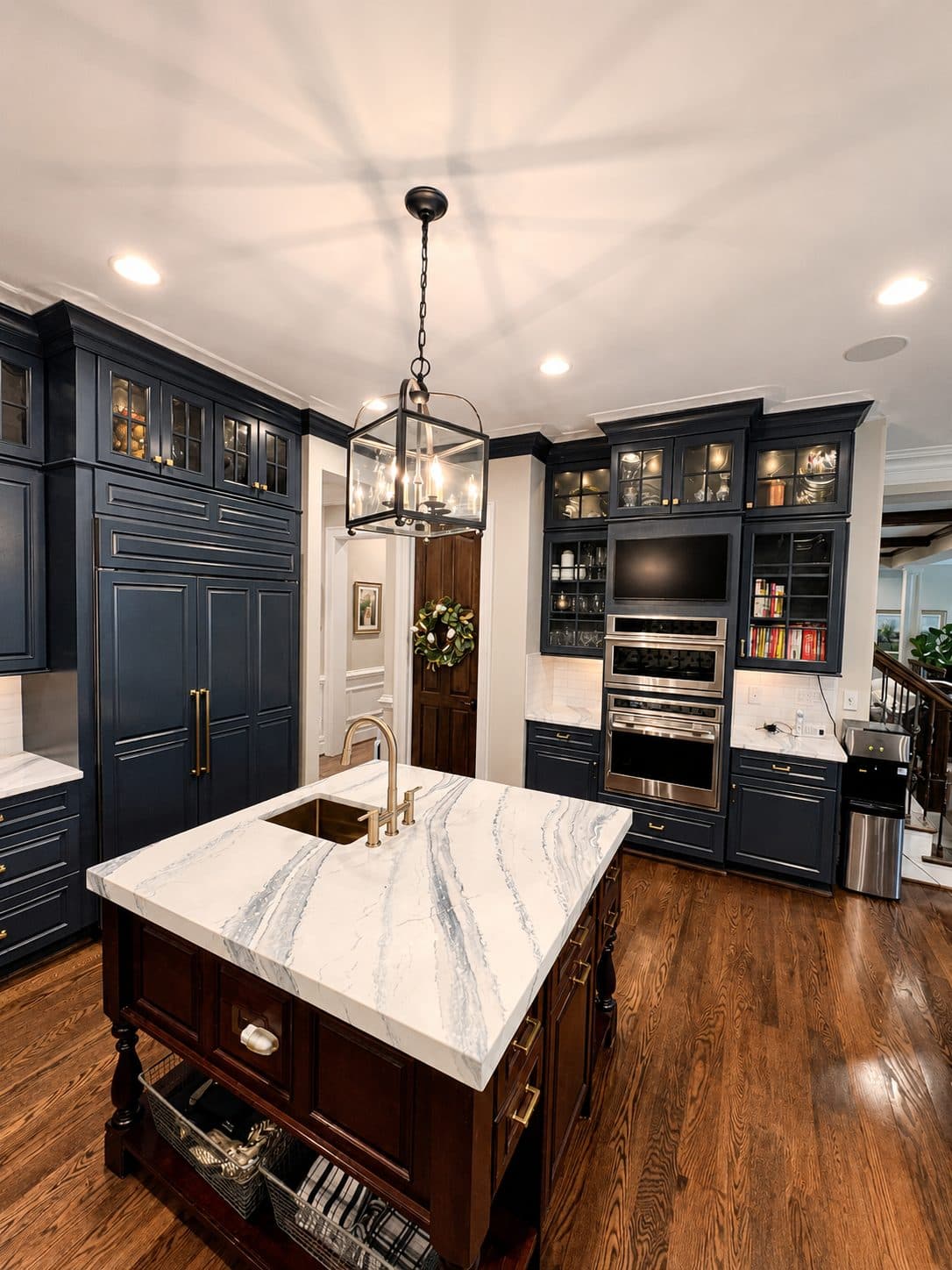 Open concept kitchen renovation in McLean, VA, navy cabinetry and marble island