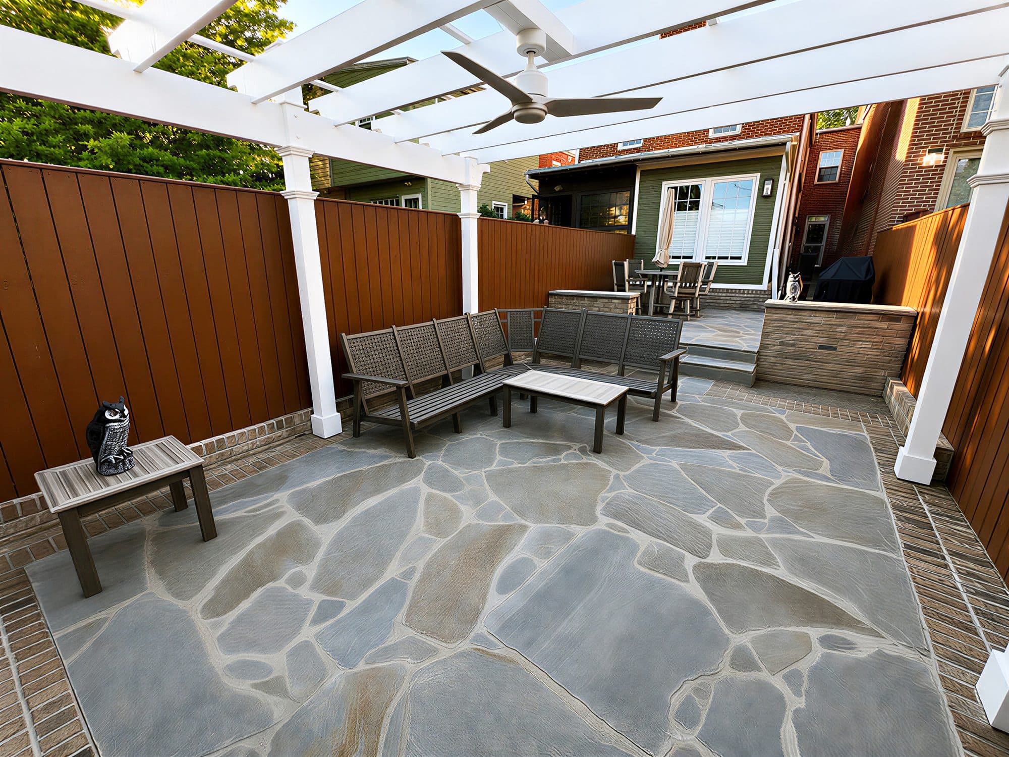 Outdoor patio renovation in Frederick, MD, pergola with ceiling fan and custom seating
