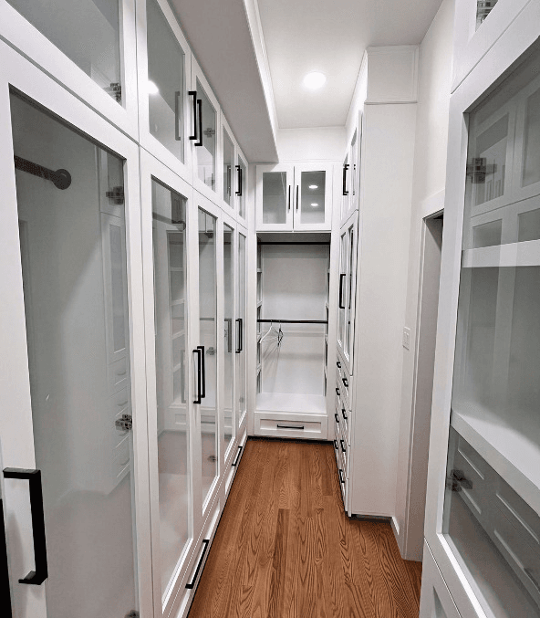 Custom walk-in closet renovation, wood shelving, gold hardware