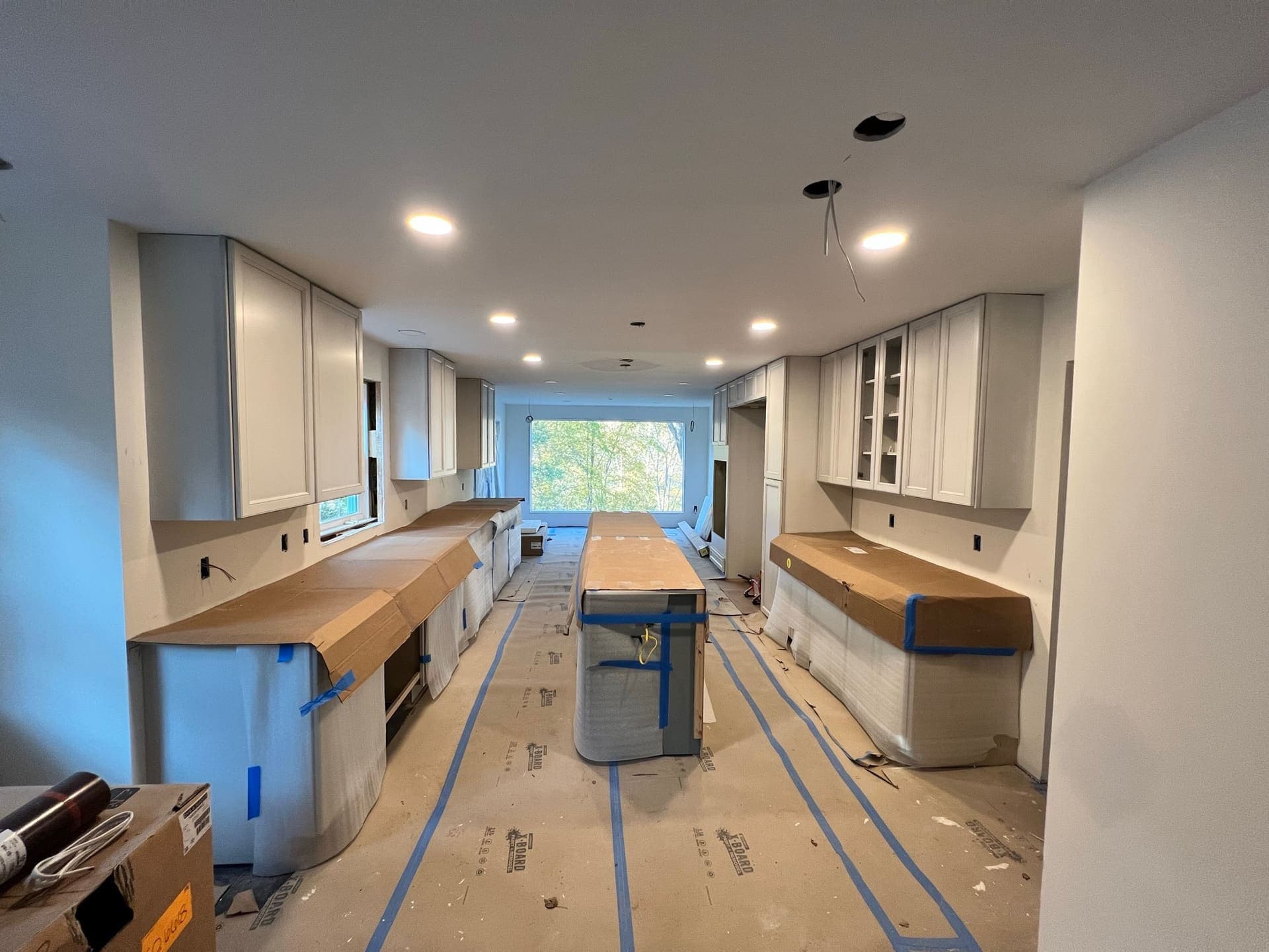 Before renovation, kitchen under construction with wrapped countertops, Hillington