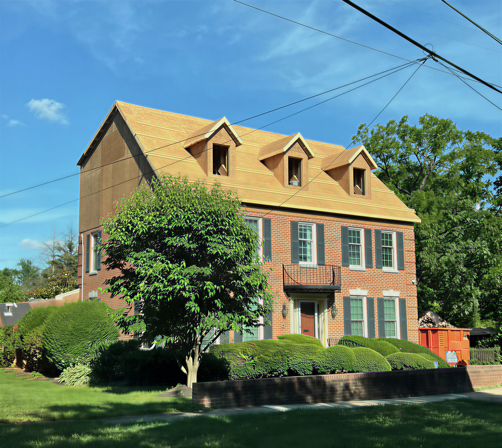 Brick colonial home with new roof framing and dormers under construction
